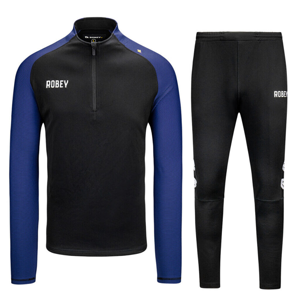 Ru Jabeth Wilson radium Robey - Performance Half-Zip Trainingspak - Zwart/ Blauw | Sportus.nl